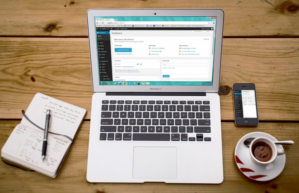 A laptop shows a content management system.