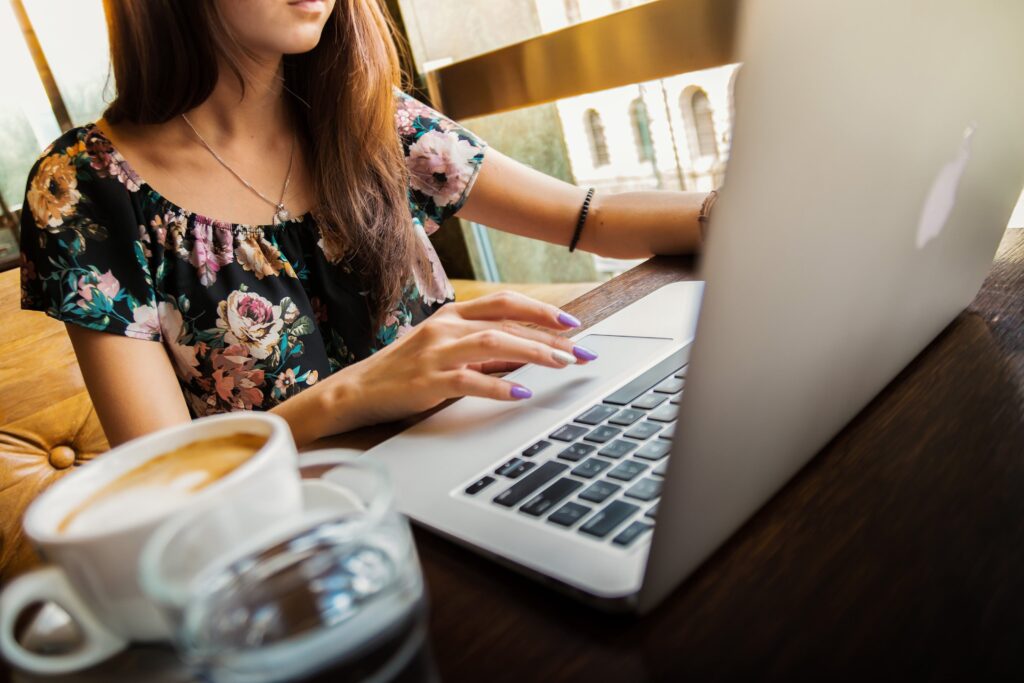 A woman types on a laptop.